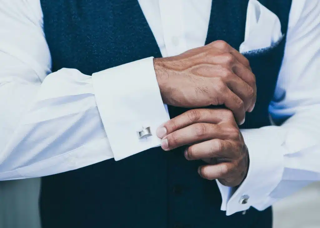 A man putting a cufflinks