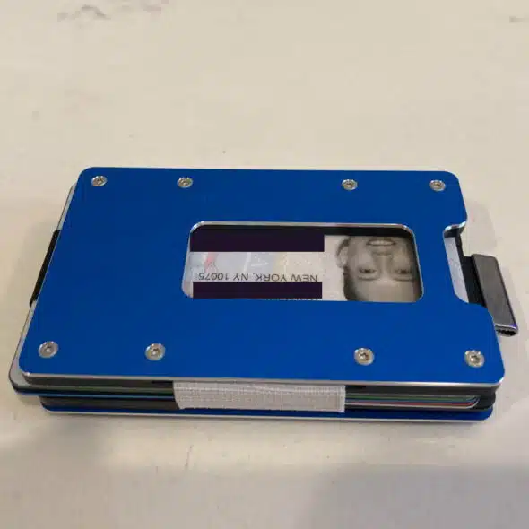A blue wallet with a clear ID slot showing an upside-down ID card with a person's photo.