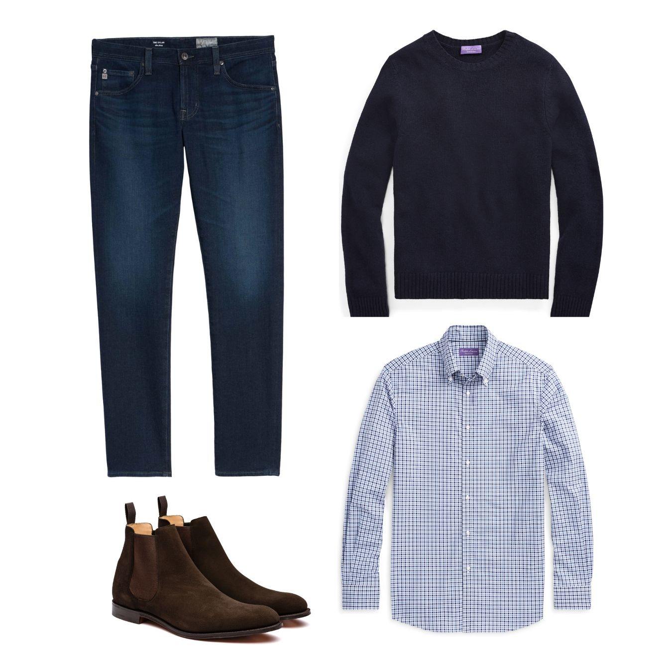 Men's dark wash denim jeans next to a navy pull-over sweater, plaid dress shirt and Chelsea boots.