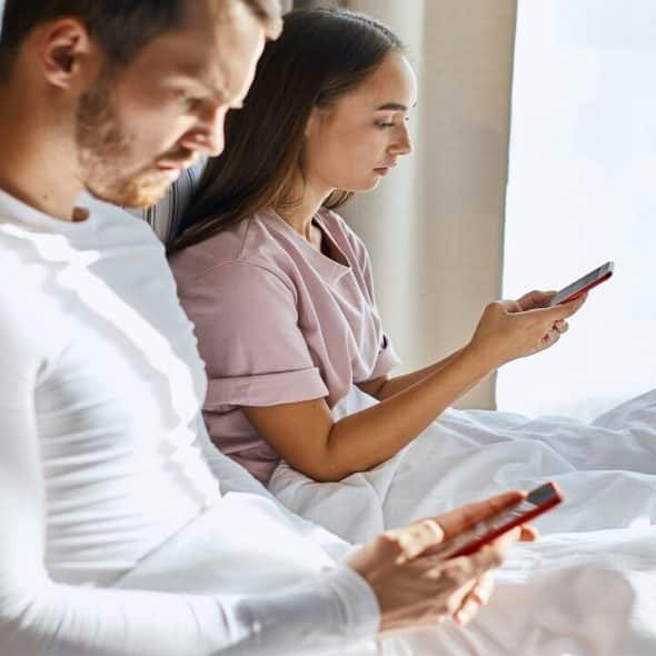 A couple busy with their phones