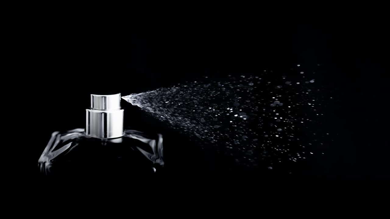 A perfume bottle in a black background.