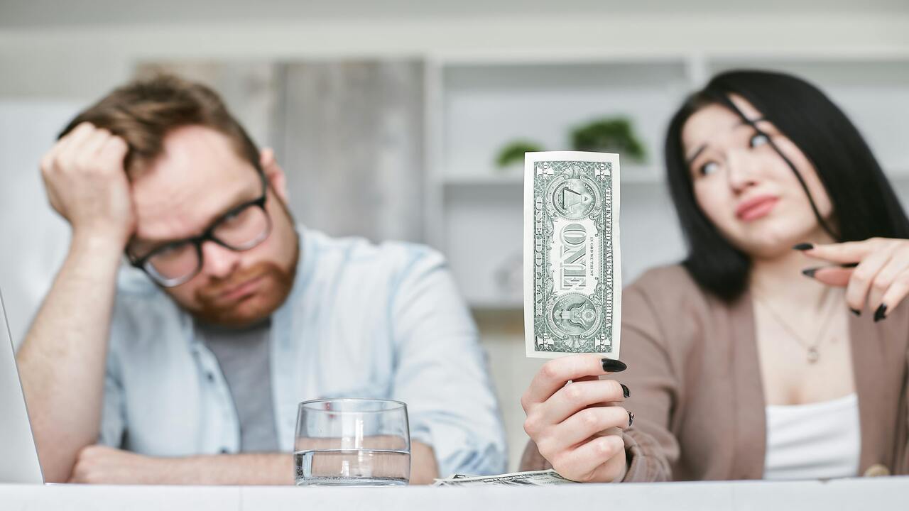 A couple looking at a one-dollar bill