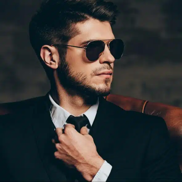 A man adjusting his necktie.