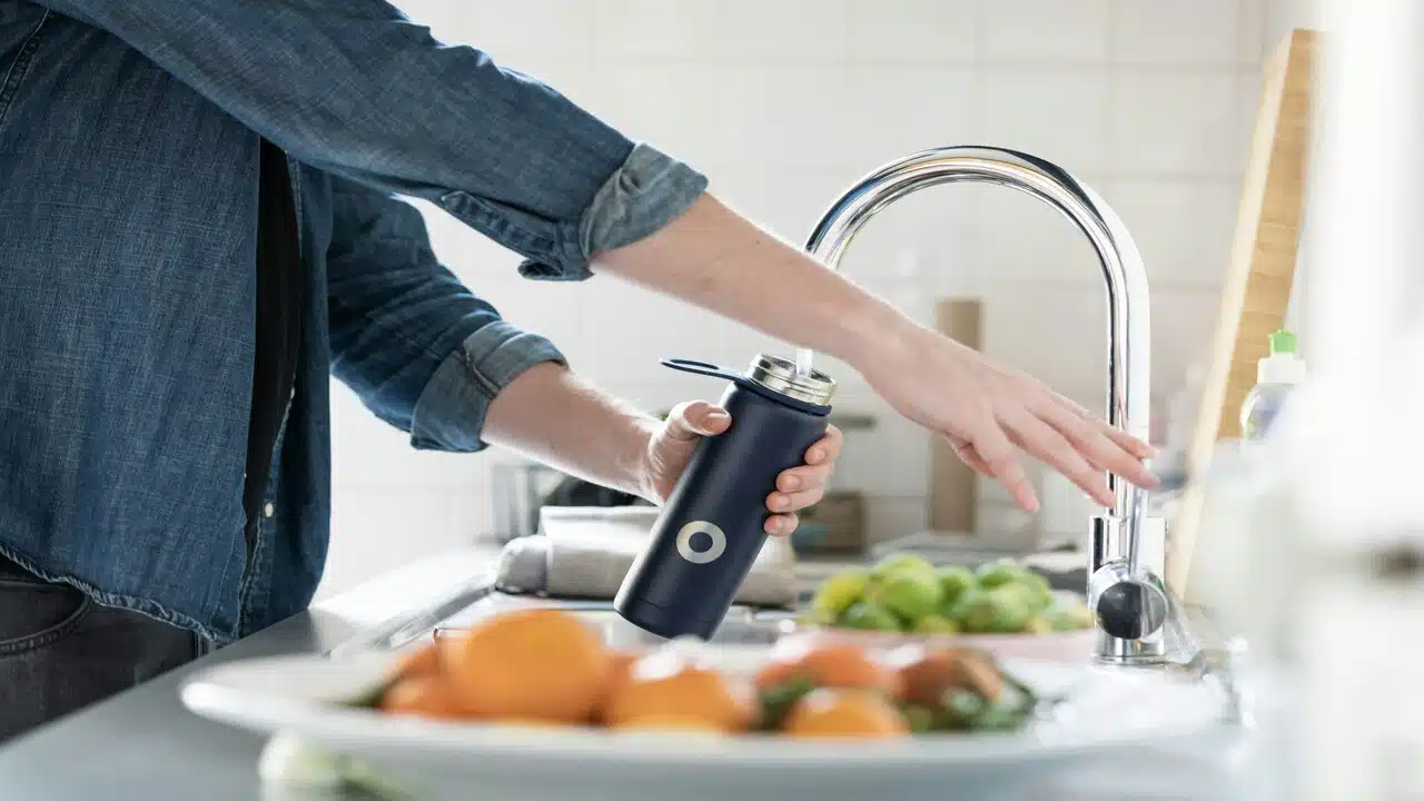 A person refilling his water bottle.