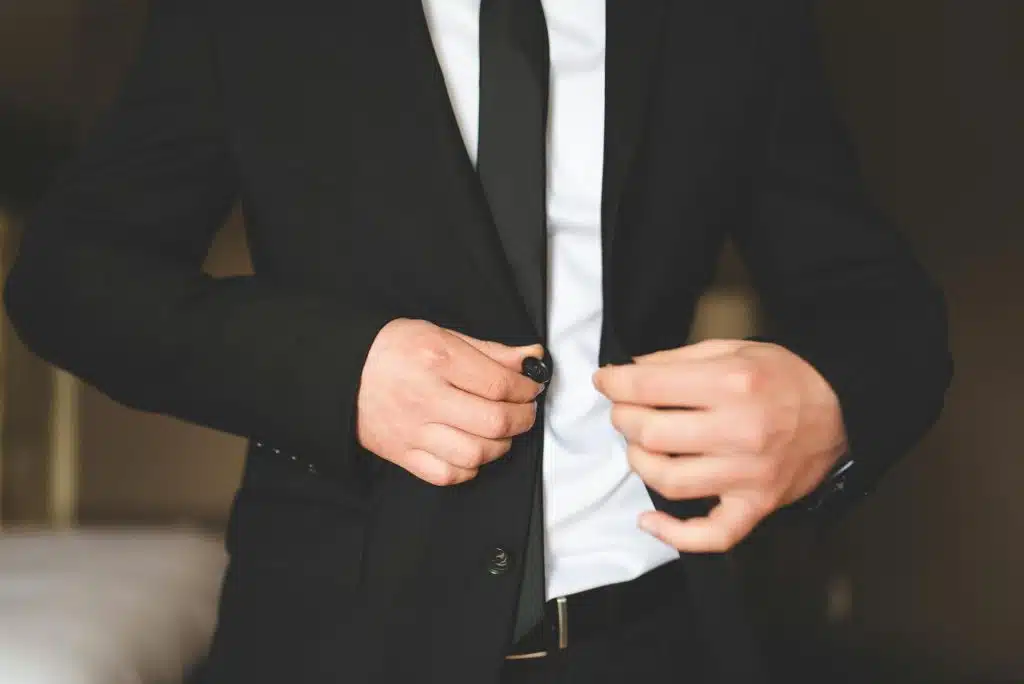 The man is wearing a black suit.
