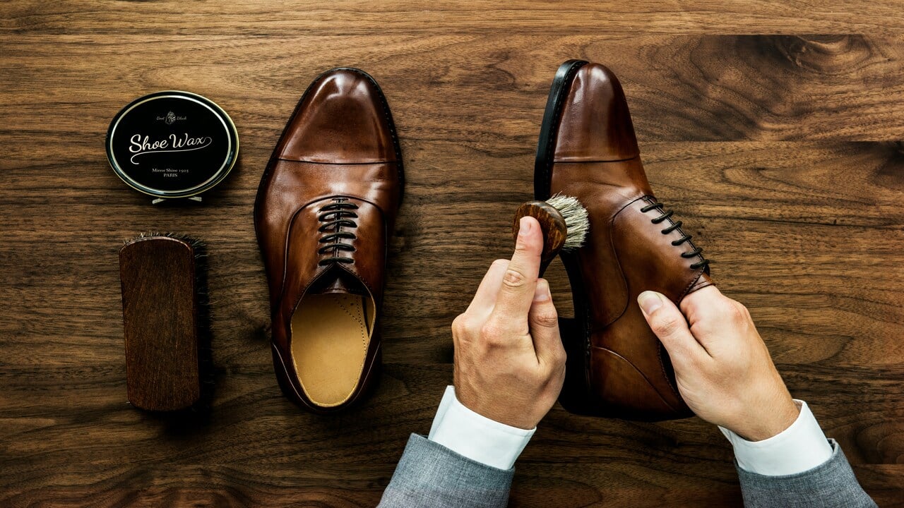 A man polishing his shoes.