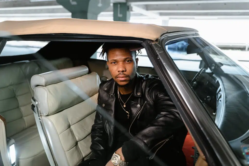 Man in Black Leather Jacket Sitting Inside Car