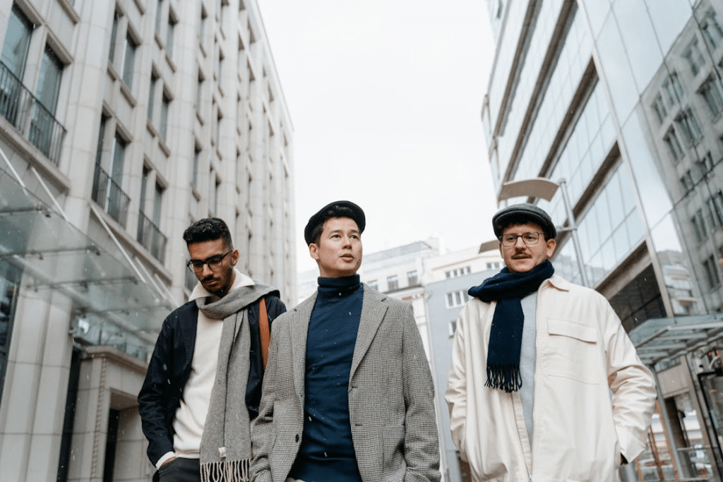 A Group of Men in Winter Clothes Walking Between the Buildings